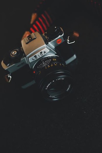 gray, black, and beige Leica point-and-shoot camera
