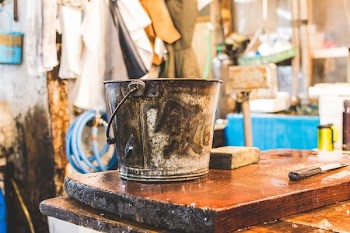 gray bucket on wooden table