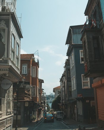 Gray Car Between Houses