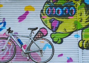 gray city bike park on near roller shutter