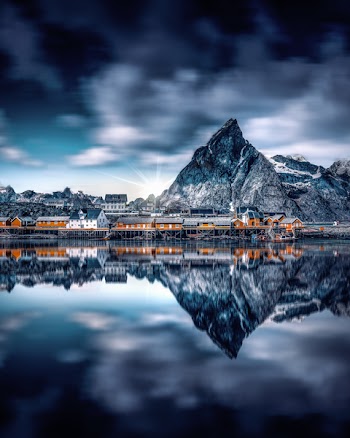 Gray City Building Reflecting on Body of Water