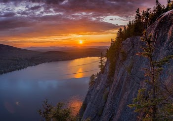gray cliff near body of water during golden hour