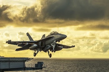 Gray Combat Air Craft Under Yellow Sky