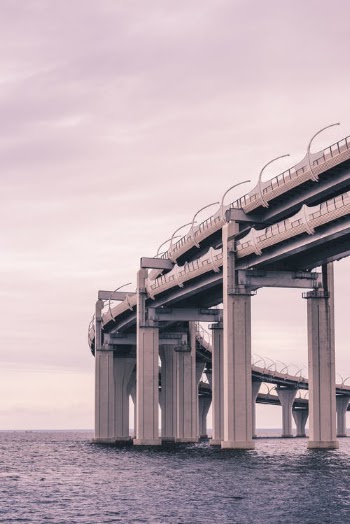 Gray Concrete Bridge Under White Sky · Free Stock Photo