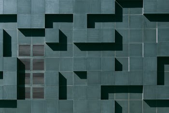 Gray Concrete Building Exterior With Geometric Design
