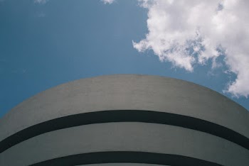 Gray Concrete Building Under White Clouds