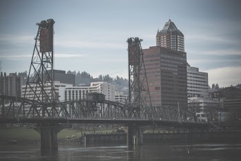 Gray Concrete Buildings Under Cloudy Sky