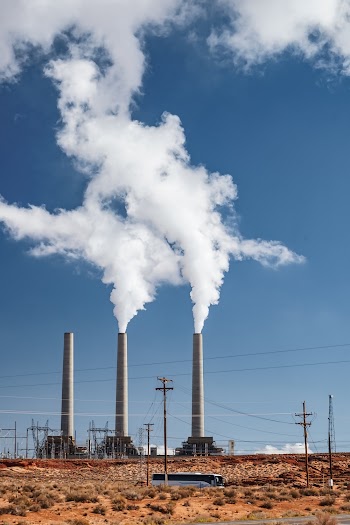 Gray Concrete Factory Chimney Releasing Smokes