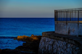 Gray Concrete Gate Near Body of Water