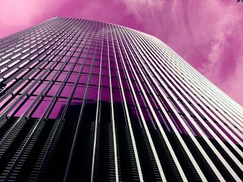 Gray Concrete High-rise Building Under Purple Sky