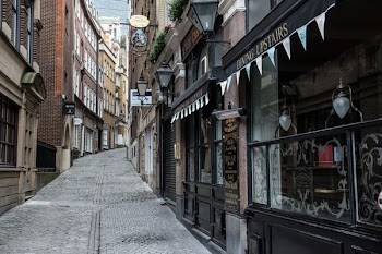 gray concrete road in between buildings at daytime