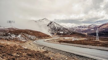 gray concrete road near brown soil during daytime