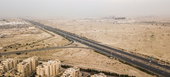 Gray Concrete Road Near White Buildings