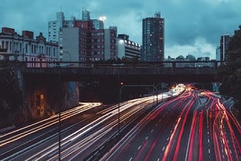 Gray Concrete Road With Buildings Light Exposure Photography