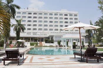 Gray Concrete Swimming Pool Beside White Building