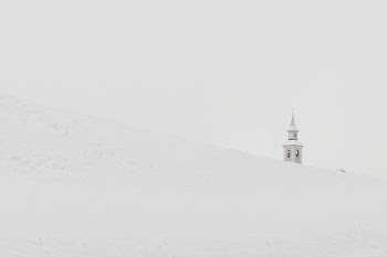 gray concrete tower on pile of snow