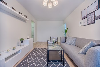 Gray Couch and Clear Glass-top Coffee Table With Black Steel Base