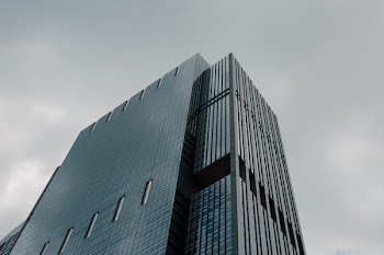 Gray Curtain-wall Building Under Cloudy Sky