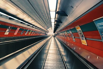 Gray Escalator Beside Posters