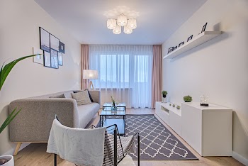 Gray Fabric Padded Sofa and Glass-top Coffee Table Inside Living Room