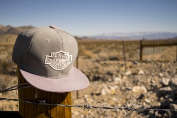 Gray Harley-davidson Motorcycles Flat-brimmed Cap Hanged on Brown Wooden Fence With Gray Barb Wires
