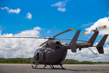 Gray Helicopter on Gray Concrete Pavement Under Blue Sky