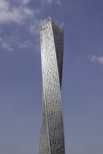 Gray High-rise Building Under Blue and White Sky