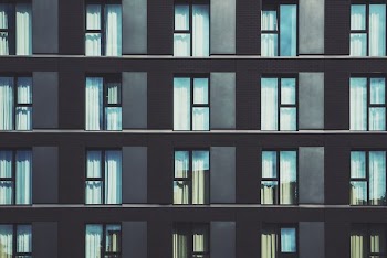 gray high-rise building with glass windows