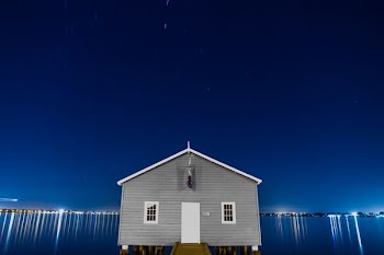 gray house surrounded with body of water photo
