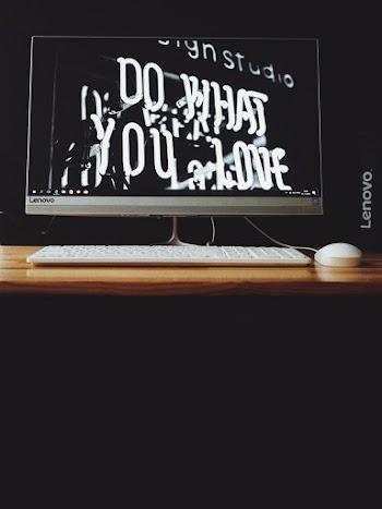 Gray Lenovo Flat Screen Monitor Displaying Do What You Love Neon Signage