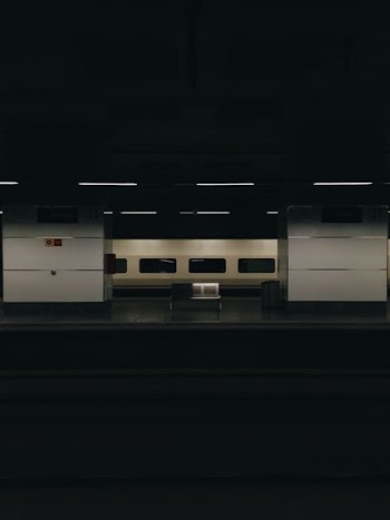 gray metal bench at the train station