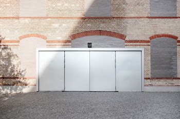 gray metal door under brown building