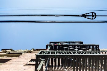 gray metal frames under black cables at daytime