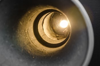Gray Metal Hole With Orange Light at Night