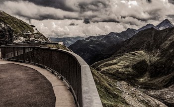 Gray Metal Railings on Top of Hill Under Gray Cloudy Sky at Daytime