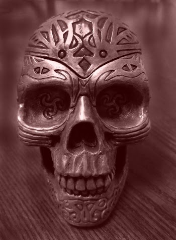 Gray Metal Skull on Brown Wooden Surface