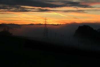 gray metal tower behind white mist at daytime