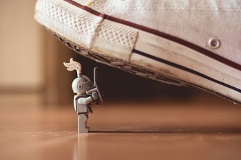 gray mini figure under white sneaker