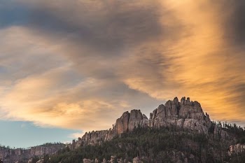 gray mountain under brown and blue sky during daytime