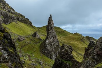 gray mountains surrounded by grass field