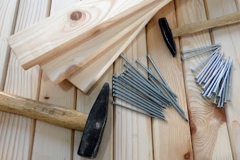 Gray Nails Beside Beige Wooden Planks and Hammers
