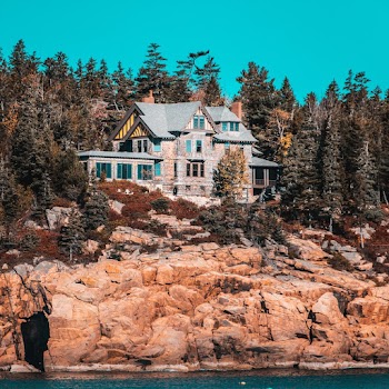 Gray Painted House Surrounding of Pine Trees