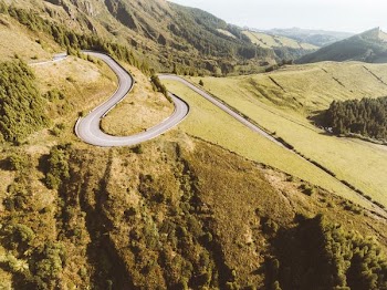 Gray Paved Road on Green Grass