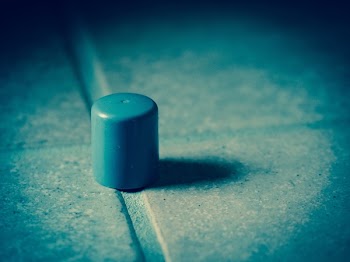 Gray Plastic Cap on Concrete Surface