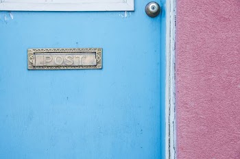 gray post signage on blue wooden door