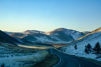Gray Road Between Brown Mountains · Free Stock Photo