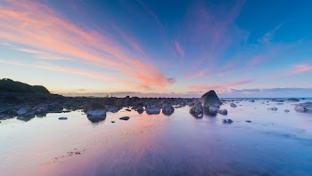 Gray Rock Formation Beside Body of Water