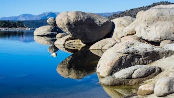 Gray Rock Formation Reflecting on Body of Water