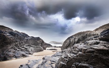 Gray Rock Formation Under Clouds at Daytime