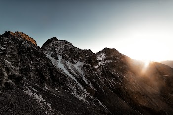 Gray Rock Mountain With White Snow during Sun Rise Aerial Photography